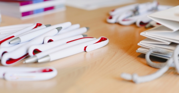 Promotional pens scattered on table