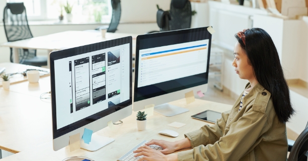 Woman designing on a desktop computer screen
