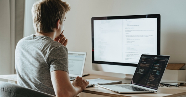Tech marketer looking at computer with Wordpress plugins