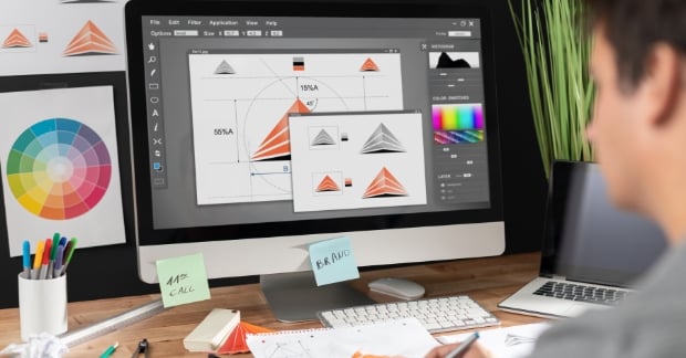 Man working on a brand refresh on a desktop computer