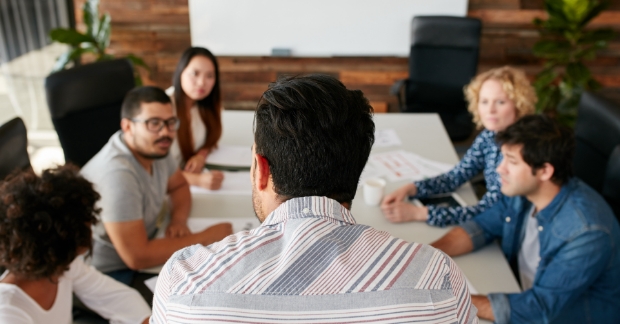 Group of people in office around table