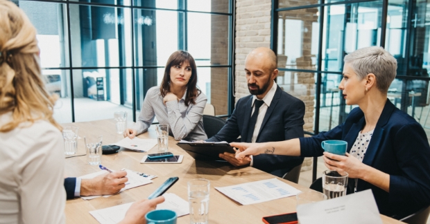 Employees looking at documents in meeting