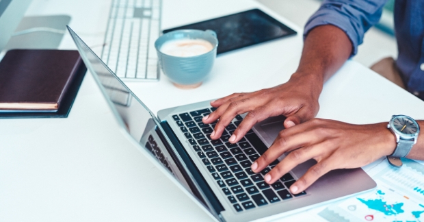 Person typing on laptop keyboard