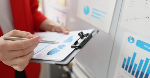 Person reviewing metrics on clipboard