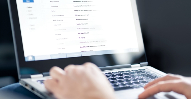person browsing email on laptop