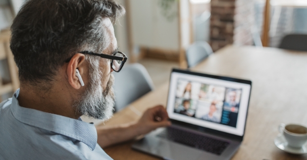Man virtually attending call with headphones in