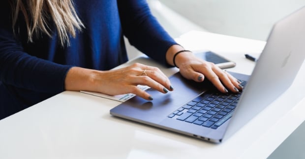 Woman typing on laptop at desk