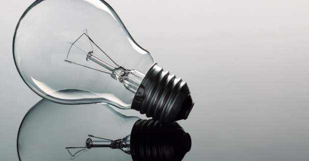 Light bulb on reflective surface