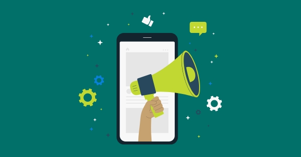 Hand holding megaphone in front of cell phone