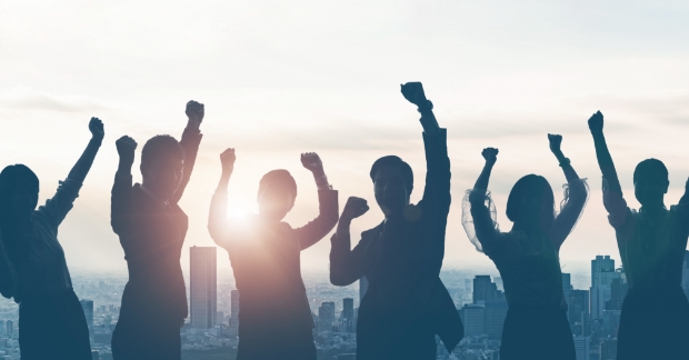 Bad stock photo of people cheering in sunset