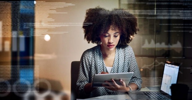 Woman looking at a tablet in an office