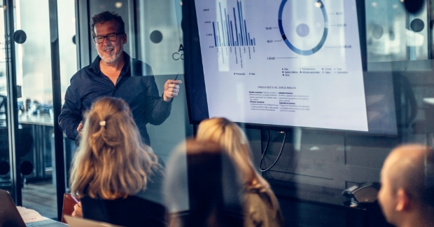 Man presenting analytics to group