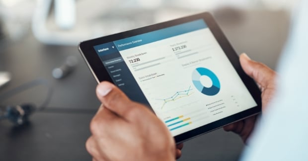 man holding tablet featuring analytics 